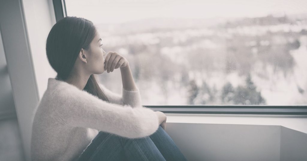 woman looking out the window wondering how to start career planning