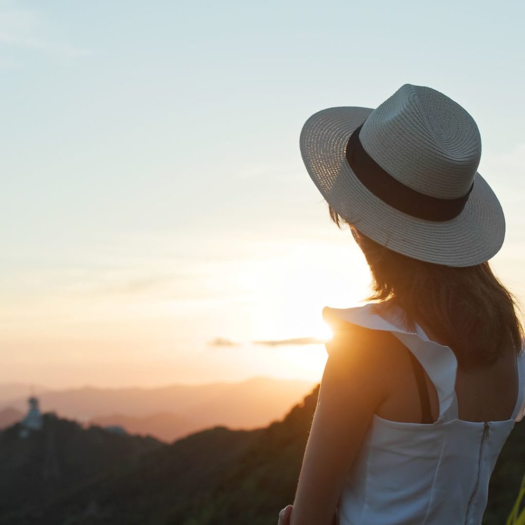 woman looking to the sunset after breaking the rules and finding a perfect career