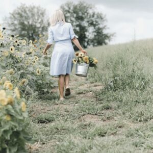 woman picking flowers in a field