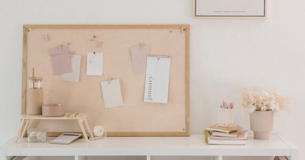 New Year, New Intentions, desk with corkboard and inspirational notes | Flourish Careers