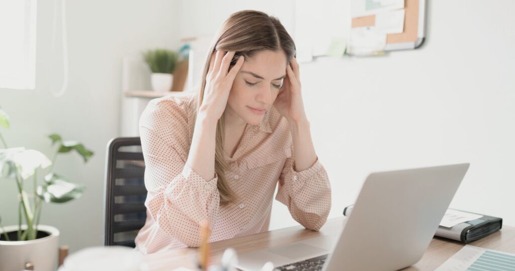 Tired woman working at desk | Featured Image | Flourish Careers